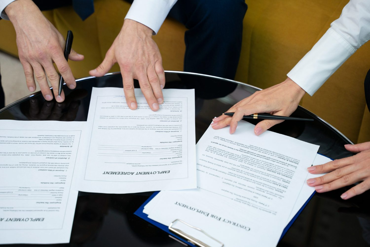 high-angle-hands-signing-documents high-angle-hands-signing-documents